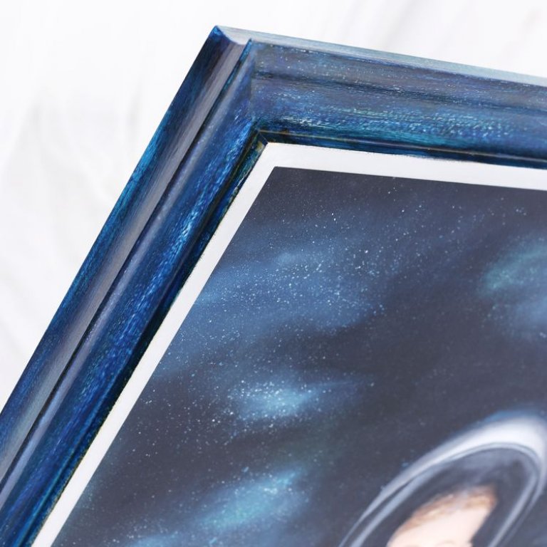 Modrý zakázkový rám pro dětský obraz ladí barevně i stylem s barvami obrázku dítěte kosmonauta