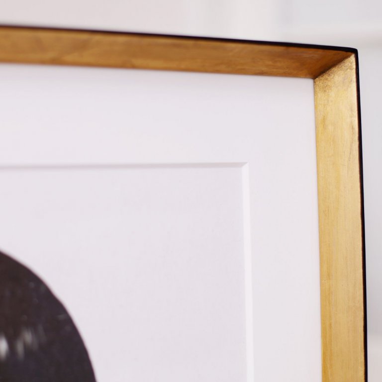 Pohled zblízka na zlacený moderní rámeček na giclée Mia Wallace od Rubena Irelanda s bílou hlubokou paspartou (pohled na pravý horní roh rámu).