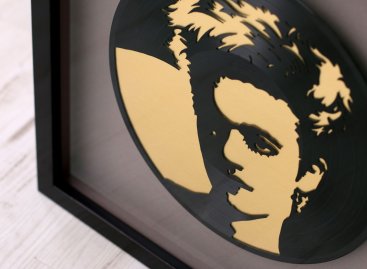 V rámu je vinyl doplněn o zlatý podklad a šedou paspartu