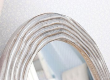 Moderně zakázkově řezbovaný rám na luxusní oválné zrcadlo ve stříbře s jemnou patinopu