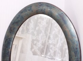 Detail neobvyklého opalizujícího povrchu oválného rámu na zrcadlo z pravého stříbra s oxidací do modrých a zelených barev